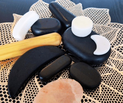 This photograph showcases massage tools a therapist uses in pleasurable relaxation treatments. These hot stone tools will help you receive targeted relief.